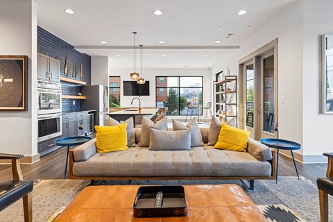 a living room with a couch and a kitchen